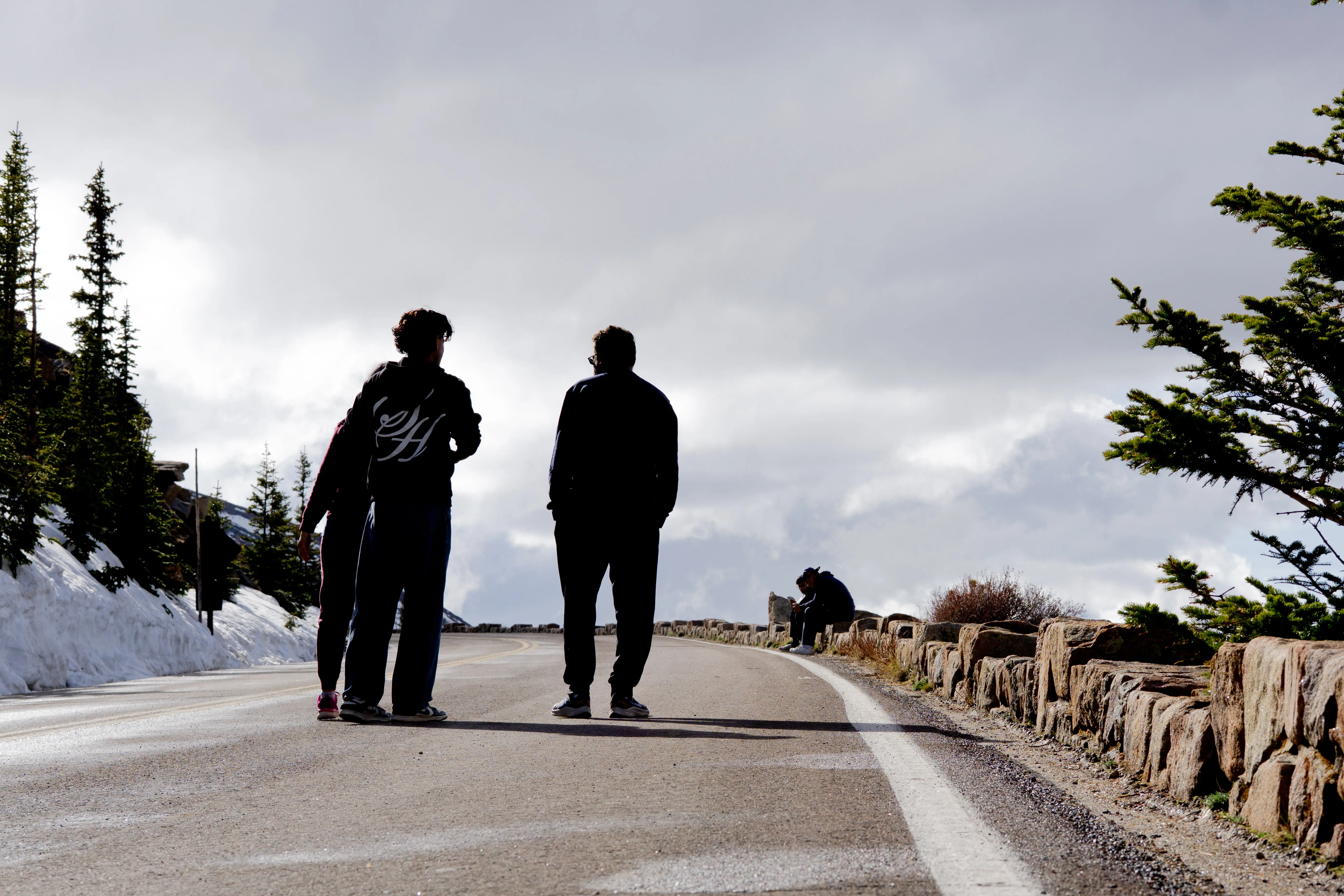 A group a people standing in the road at Rocky Mountain National Park.
